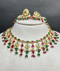 Elevate your wedding or special occasion look with this stunning Pakistani-style necklace set, expertly crafted with brass and adorned with beautiful quartz stones. The intricate design and sparkling stones make this set perfect for bridal wear or as a statement piece for any formal event. The set includes a matching necklace and earrings, adding a touch of elegance and sophistication to your outfit. Whether you're walking down the aisle or attending a wedding, this set is sure to turn heads." Multicolor Temple Necklace With 17 Jewels For Wedding, Round Temple Necklace With Gemstones For Weddings, Round Gemstone Temple Necklace For Weddings, Gemstone Temple Necklace For Wedding, Wedding Temple Necklace With Gemstones, Celebration Temple Jewelry With Stones, Festive Bridal Necklace With Gemstones, Kundan Gemstone Jewelry Sets For Weddings, Celebration Chandbali Jewelry With Stones