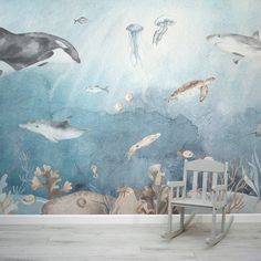 an ocean mural with dolphins, jellyfish and other marine creatures on it's wall