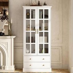 a white bookcase with glass doors and drawers in a room next to a fireplace