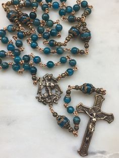 This beautiful rosary is handmade with 20 gauge solid broze wire and bronze rosary medals. The stones are 6mm and 8mm natural apatite gemstones. You won't be disappointed with this beauty! Center: Saint Michael slaying the enemy Crucifix: Reproduction of antique Spanish crucifix Handmade Bronze Spiritual Rosary, Handmade Spiritual Bronze Rosary, Bronze Natural, Beautiful Rosary, Saint Michael, Beauty Center, Rosary Catholic, Wire Work Jewelry, Rosary Beads