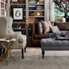 a living room filled with lots of furniture and bookshelves full of bookcases