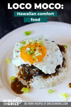 a white plate topped with rice covered in meat and an egg on top of it