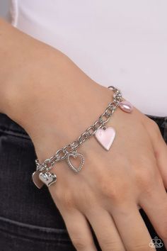 A textured silver heart silhouette, sleek silver heart, sunburst-detailed silver heart, red-painted heart, and baby pink pearl heart dangle along a silver chain for a romantic declaration. Features an adjustable clasp closure around the wrist. Sold as one individual bracelet. Pink Metal Jewelry With Adjustable Chain, Pink Nickel-free Charm Bracelet, Silver Metal Double Heart Bracelet, Pink Adjustable Chain Charm Bracelet, Silver Double Heart Metal Bracelet, Silver Charm Bracelet With Heart Beads, Pink Heart-shaped Sterling Silver Bracelets, Metal Open Heart Jewelry With Heart Beads, Trendy Silver Charm Bracelet With Heart Beads