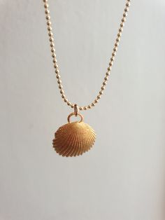 A sea shell necklace made of natural shells casted in brass and plated with quality, nickel free 14k gold plating. The necklace is made of 14k gold filled. Gold Minimalist Necklace For Beach, Minimalist Gold Necklaces For The Beach, Minimalist Gold Necklace For Beach, Ocean-inspired Gold Pendant Necklace, Handmade Gold Ocean-inspired Charm Necklaces, Handmade Ocean-inspired Gold Charm Necklaces, Dainty Gold Shell Charm Necklace, Ocean-inspired Gold Shell Charm Necklace, Dainty Gold Shell-shaped Necklace