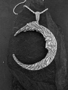 "I hand cast all my pieces using the lost wax casting method. This Moon Pendant is Sterling Silver, The included chain is a Sterling Silver Rope chain. You may chose 16, 18 or 20 inch at the same price. Other length available at sightly higher prices. Please ask your needs. This Moon measures 3 5/8\" tall by 2 1/2\" across. You may call me with questions, often I am out so please use my machine. 831-476-3176. Satisfaction Guaranteed I send items USPS First Class unless otherwise directed. I send Hand Forged Sterling Silver Celestial Necklace, Symbolic Hand-cast Jewelry, Artisan Crescent Jewelry Hand Forged, Artisan Hand Forged Crescent Jewelry, Artisan Hand-forged Crescent Jewelry, Unique Engraved Moon-shaped Necklace, Unique Moon-shaped Engraved Necklace, Collectible Round Pendant With Moon Charm, Unique Moon Shaped Engraved Necklace