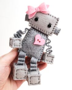 Make your own little plush robot with a heart and bow This sewing pattern makes a robot that sits about 4 inches tall. However you can print the pattern pieces larger or smaller to make a different sized robot. The PDF download includes: *Full size printable pattern pieces *Step by step instructions *16 color photographs showing each step You will need these supplies: Wool felt Embroidery thread and needle Stuffing (polyester fiberfill or wool) Buttons for eyes Heart button Scissors All stitchin Robot Plush, Make Your Own Robot, Felt Sewing Kit, Diy Plush, Bow Diy, Felt Animal Patterns, Sewing Stuffed Animals, Diy Felt, Diy Sewing Pattern