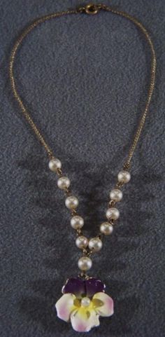 I am offering you this truly exquisite vintage extra wide bold bib dangle style lavaliere necklace, with spectacular round shaped faux style pearls, with this amazing dimensional enameled pansey flower, in a very bold style design. The design has a very elegant flair to it what a spectacular design so very regal. The entire surface of this regal bib style necklace is encrusted with these spectacular color saturated stones and enamel work and these stones are large !! Measuring a very versatile 1 Vintage Pearl Necklace With Chain For Parties, Elegant Vintage Charm Dangle Necklaces, Elegant Metal Chain Necklace With Vintage Charm, Vintage Metal Pearl Necklace For Formal Events, Vintage Metal Jewelry With Pearl Pendant, Vintage Pearl Drop Pendant Jewelry, Vintage Pendant Necklace With Pearl Chain, Vintage Formal Pearl Necklace, Vintage Pearl Choker Jewelry