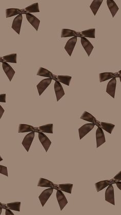 a brown bow pattern on a tan background