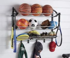 a rack with various sports items hanging from it's sides and on the wall