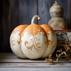 an orange and white pumpkin sitting on top of a table