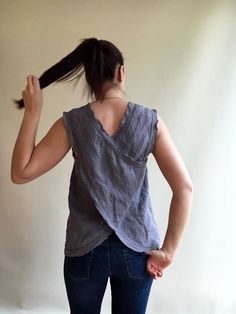 "This linen top is perfect for the hot summer days. Made from wonderfully textured and high quality European linen. It features a pinafore cut and frayed edges. Linen being highly absorbent fabric, the top will allow your body to breathe and feel at ease. And the more you wear and wash it the more it will gain in its character and softness. Choose from multiple linen fabrics available. The top will be custom made for you within 10 days with great attention to finishing. You will receive the top Cotton Vest Top For Vacation, Summer Tank Top Vest, Linen Crew Neck Beach Top, Linen Crew Neck Top For Beach, Sleeveless Linen Tops For The Beach, Summer Sleeveless Cotton Tops, Cotton Sleeveless Blouse For Summer, Summer Short Sleeve Tank Top For Beach, Summer Cotton Tank Blouse