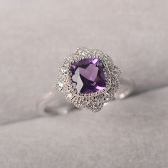 ◆ The ring is handcrafted from sterling silver and decorated with a dazzling 7*7 mm amethyst and cluster CZs. It is suitable for engagement/anniversary/daily occasion. ◆ Production Description: Main stone Type: Amethyst Main Stone Shape: Cushion cut Main Stone Size: 7*7 mm(1.5ct) Side stone: CZ 1.3mm*12 Metal: 925 Sterling silver - Other options available in the drop down menu ◆ Customization: √Add Engraving √Other Metal Type Available √Other Gemstones & Shapes Available √Personalization Req Flower Cluster Ring, Oval Sapphire Ring, Green Sapphire Ring, Lavender Amethyst, Engagement Ring Prices, Minimalist Engagement Ring, Flower Cluster, Vintage Engagement Ring, London Blue Topaz Ring