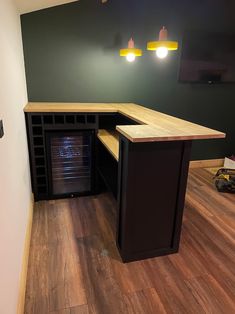 an empty room with wood flooring and green walls