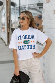 Whether you're cheering on your team from the sidelines or enjoying the festivities at the tailgate, our Spring Collection Game Day Essentials are sure to keep you looking and feeling fabulous all season long. Join the fashion game and make every game day unforgettable! From The Sidelines, Florida Gators, Women Crop, Spring Collection, Crop Tee, Game Day, Fashion Games, The Fashion, Florida