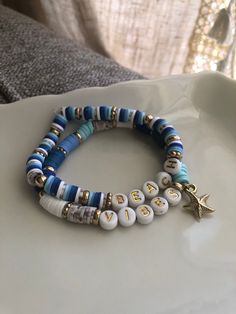 Ready for summer, this "Beach Vibes" bracelet set says it all!  Made with blue, white, and gray and tan speckled clay beads, gold plastic beads, white and gold plastic letter beads, complete with a gold plastic starfish charm.  On a stretchy elastic cord, this set fits most! Beach Bracelets Clay Beads, Bracelets Clay Beads, Fun And Easy Diys, Clay Bracelets, Easy Diys, Beach Bracelet, Speckled Clay, Polymer Clay Bracelet, Moon Bracelet