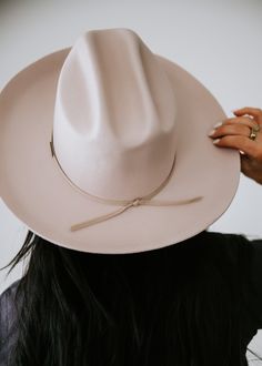 A classic cattleman crown made to be styled for the city as much as the countryside. This hat features an upturned brim + a tall crown, giving Ezra a modern + feminine feel. Ezra comes with a removable tonal grosgrain band featuring a brass Gigi Pip pin. Hat is M-L = 59" Elegant Everyday Hat Band With Flat Crown, Chic Adjustable Fedora With Flat Crown, Chic Flat Brim Felt Hat For Everyday, Chic Flat Brim Felt Hat, Chic Everyday Fedora With Flat Crown, Chic Everyday Felt Hat With Short Brim, Chic Everyday Felt Hat With Flat Brim, Chic Panama Hat With Short Brim, Chic Short Brim Panama Hat For Everyday