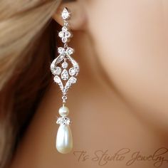 a close up view of a woman's ear with pearls and diamonds on it