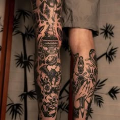 a man's legs with tattoos on them