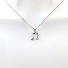 a musical note necklace on a mannequin