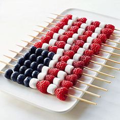 an american flag made out of marshmallows on a white plate with toothpicks