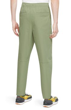 Sporty and comfortable, these lightweight pants topped with a drawstring waist feature handy pockets and a fit that tapers to stay close and out of your way. 100% polyester Machine wash, dry flat Imported Athleisure Ankle-length Pull-on Pants, Green Tapered Leg Pants With Pull-on Style, 4-way Stretch Tapered Leg Spring Pants, Spring 4-way Stretch Tapered Leg Pants, Nike Casual Bottoms With Straight Hem, Nike Athleisure Pants For Spring, Nike Spring Athleisure Pants, Spring Nike Trousers, Nike Relaxed Fit Solid Color Bottoms