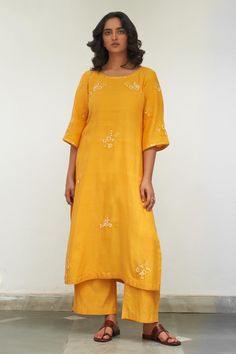 Yellow kurta with sequin, resham, mirror embroidery in floral applique pattern. Paired with pant and dupatta.
Components: 3
Pattern: Embroidery
Type Of Work: Resham, mirror, sequin, floral
Neckline: Round
Sleeve Type: Three quarter
Fabric: Mangalgiri Cotton
Color: Yellow
Other Details: 
Scallop bordered sheer dupatta
Length:
Kurta: 46 inches
Pant: 38 inches
Approx. product weight: 1-3 kg
Model height: 5ft 7inches, wearing size M
Occasion: Sangeet - Aza Fashions Festive Palazzo Set With Straight Kurta And Mirror Work, Festive Palazzo Set With Mirror Work, Festive Chanderi Palazzo Set With Mirror Work, Dola Silk Palazzo Set With Mirror Work, Chanderi Straight Kurta Set With Mirror Work, Straight Kurta Palazzo Set With Resham Embroidery For Navratri, Navratri Chanderi Palazzo Set With Resham Embroidery, Navratri Palazzo Set With Resham Embroidery And Straight Kurta, Straight Kurta With Gota Work In Chinon