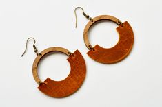 "A new twist on our Hope Hoops, these unique earrings feature genuine leather in your choice of autumn color. All hooks are lead and nickel free.  Earring measurements are from the top of the hook to the bottom of the earring.  Drop length is approximately 2 5/8\"." Handmade Leather Hoop Earrings, Handmade Brown Hoop Earrings For Everyday Wear, Everyday Handmade Brown Hoop Earrings, Modern Orange Earrings For Everyday Wear, Modern Brown Leather Earrings, Handmade Brown Faux Leather Earrings, Modern Brown Earrings With Ear Wire, Nickel Free Brown Earrings For Everyday Use, Everyday Brown Hoop Earrings With Ear Wire