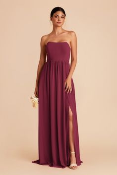 a woman wearing a strapless, purple bridesmaid dress with thigh high slit