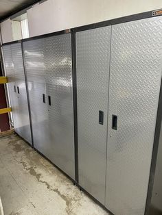 several metal lockers are lined up in a storage room with no doors on them