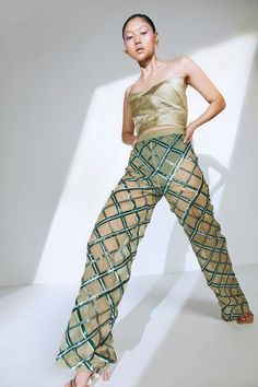 Glam up this season with the perfect embellished sequin pants for your next night out in the city. Pair it with one of our bustiers or corsets to complete the look. Hand-embroidered sequin pattern Straight pants High-waisted Semi-sheer Knitted underpants in green Concealed zipper on the side Fabric: Net Model wears a size XS. Materials used: Net Product care: Dry clean only. DO NOT steam the leather. To iron the piece, place a piece of cotton or muslin fabric on the piece to press. DO NOT iron d Corset Pants, Sheer Pants, Sequin Pattern, Sequin Pants, Muslin Fabric, Bustiers, Corsets, Straight Pants, Hand Embroidered