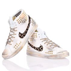 Nike Hi Leo Studs is the custom women's sneaker for a street-inspired look. The iconic Nike swoosh is adorned with sparkling animal print leopard glitter in perfect contrast with the gold studs matched to the gold lurex laces. The final touch in full Mimanera style is the vintage-effect gold and black stripes. &nbsp;Nike Hi Leo Studs will also come with its original white laces. Leopard Nike Shoes, Nike Leopard Sneakers, High-top Leopard Print Sneakers For Streetwear, Leopard Print High-top Leather Sneakers, Sneaker Wedge, Custom Shoes, Luxury Retail, Manolo Blahnik, Bridal Shoes