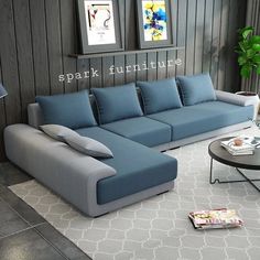 a blue and grey couch sitting on top of a white rug in a living room