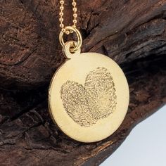 Fingerprint pendant handcrafted in pure silver / or dipped in 24K gold. Each Charm fits two fingerprint. The charm can be hung on necklace, bracelet and leather cord (priced separately). Please upload the impression of the fingerprint black ink on white paper via private message to me. We will create your ~One of a kind~ fingerprint impression that will be mail back to you as a unique piece of jewelry. Material: Pure / fine, reclaimed silver .999 / 24K gold. ~ The Impressions on the featured Jew Gold Hand Stamped Round Pendant Jewelry, Gold Hand Stamped Round Pendant, Etched Pendant Jewelry For Commemoration, Symbolic Stamped Gold Jewelry, Stamped Pendant Jewelry For Commemoration, Stamped Gold Pendant Jewelry, Stamped Round Pendant Jewelry For Commemoration, Keepsake Gold Stamped Jewelry, Minimalist Etched Jewelry For Keepsake