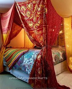 the canopy bed is decorated with bright colored fabrics and lights in the room behind it