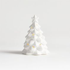 a white ceramic christmas tree on a white background