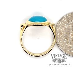 The combination of yellow gold and turquoise, though not seen as often as other metals, offers a striking contrast. The round cabachon fine turquoise in this estate ring is often referred to as "robin's egg" blue with almost no secondary coloration, and is usually considered the most desirable color. It is bezel set in a polished 18 karat yellow gold setting with triangular gold buttresses incorporated into the shoulder design, tapering down to a 2.5 mm shank. The ring is size 5.5. Oval Turquoise Cabochon Ring In Yellow Gold, Oval Yellow Gold Turquoise Ring With Cabochon, Classic Gold Turquoise Ring With Round Shape, Gold Turquoise Oval Cabochon Ring, Classic Yellow Gold Turquoise Cabochon Ring, 14k Yellow Gold Turquoise Cabochon Ring, Classic Cabochon Turquoise Ring In Yellow Gold, Blue Domed Cabochon Jewelry, Classic Yellow Gold Turquoise Ring