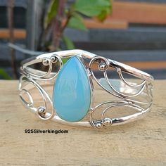 Chalcedony Bangle, 925 Sterling Silver, Party Wear Bangle, Shining Bangle, Wedding Gift, Unique Bangle, Stylish Bangle, Unique Gift. Aqua Chalcedony Gemstone Benefit Chalcedony has the power to soothe self-doubt and bring inner peace to the wearer. It is believed that blue chalcedony helps in calming and centering the emotional energy, while encouraging the wearer to acquire tranquility. Healing: This gem is best for people who have a propensity to get worried easily. Aqua Chalcedony is a cool b Elegant Turquoise Bangle For Wedding, Sterling Silver Bangle For Party, Elegant Turquoise Bangle For Formal Occasions, Bohemian Sterling Silver Party Bracelets, Elegant Adjustable Turquoise Sterling Silver Bracelet, Bohemian Sterling Silver Bracelets For Party, Bohemian Sterling Silver Bracelet For Parties, Adjustable Sterling Silver Bracelet For Party, Handmade Sterling Silver Bracelets For Parties