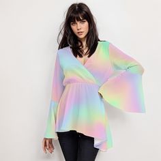 * Elevate your style with our Ombre Rainbow Top, a perfect blend of vintage charm and modern flair for women. * Embrace the 70s vibe with this Boho Top featuring groovy bell sleeves and a high empire waistline. * Made for the free-spirited, this 70s Disco Top boasts a stunning rainbow ombre pattern print. * Crafted with care, this Hippie Top combines comfort and style with its wrap top bodice design. * Stand out from the crowd in this Bohemian Top Women, perfect for adding a pop of color to any outfit. * Whether you're dancing the night away or soaking up the sun, this Ombre Top Women is sure to turn heads. Designed in California by Trendy Hip Buys. Handmade to order from overseas. 100% Polyester ● Fabric: 100% polyester ● Regular fit ● V-neck, Bell Sleeves ● Fabric weight: 80gm ● Care Ins Retro Rainbow Print Top For Spring, Retro Spring Top With Rainbow Print, Fitted Rainbow Top For Spring, 70s Inspired Multicolor Summer Tops, 70s Inspired Multicolor Tops For Spring, Retro Rainbow Tops For Spring, Flowy Multicolor Party Tops, Multicolor Hippie Blouse For Fall, Fall Hippie Multicolor Blouse