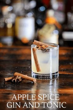 a glass filled with liquid and cinnamon sticks