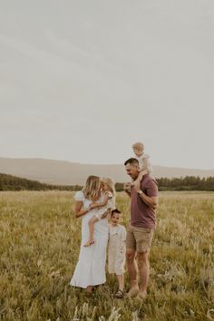 a family standing in the middle of a field