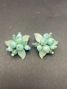 For style are a stunning pair of 1940s early plastic beaded cluster clips. The clips are brass, a sign of an older vintage pair of clip on earrings. Despite their age they are in excellent condition and will complement any 1940s or 50s outfit. Or add a bit of vintage individuality to your style, and they are a very attractive and collectible colour.  The clips are secure, the earrings are a good size at 3.5 cm by 3.5cm, and are sure to be noticed. Any box in the photo's is for display only. Vintage Handmade Clip-on Earrings For Party, Handmade Vintage Clip-on Earrings For Party, Vintage Handmade Clip-on Earrings For Wedding, Handmade Vintage Clip-on Earrings For Wedding, Vintage Beaded Clip-on Earrings For Party, Vintage Cluster Earrings For Wedding, 50s Outfit, Vintage Silver Rings, Turquoise And Purple