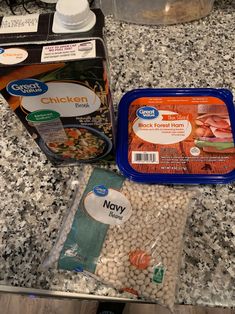 ingredients to make chicken broth sitting on a counter next to a container of soup