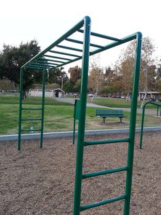 an empty playground with swings and benches