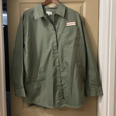 New Without Tags! Size Medium/Large Nylon Olive Green Relaxed-Fit. *Please See Photos For Flaw On The Back Of The Jacket. Comes From A Smoke-Free And Dog-Friendly (Non-Shedding) Home. Oversized Green Windbreaker For Spring, Green Oversized Windbreaker For Spring, Khaki Long-sleeve Windbreaker For Work, Khaki Long Sleeve Windbreaker For Work, Oversized Windbreaker With Pockets For Work, Spring Utility Windbreaker For Work, Relaxed Fit Long Sleeve Windbreaker For Spring, Oversized Windbreaker For Spring Workwear, Spring Long Sleeve Relaxed Fit Windbreaker