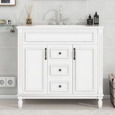 a bathroom vanity with white cabinets and drawers