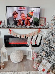 a living room decorated for christmas with stockings and stockings hanging from the mantel above it