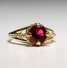 Gorgeous gold plated Garnet Crystal Ring-  gemstone- with dazzling crystals. size 7 1/4. It shines like real gold. GREAT Gift! No Tarnish It will come in a gift bag Elegant Gold Crystal Ring For Valentine's Day, Gold Birthstone Ring With Cubic Zirconia, Classic Gold Crystal Ring With Birthstone, Gold Crystal Ring With Stone Setting As Gift, Gold Crystal Ring With Stone Setting For Gift, Gold Cubic Zirconia Crystal Ring For Valentine's Day, Classic Gold Crystal Ring With Accent Stones, Gold Crystal Ring With Stone Setting, Gold Crystal Ring With Accent Stones For Formal Events