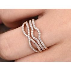 a woman's hand with a diamond ring on top of her finger and the band is