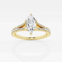 a yellow gold engagement ring with a pear shaped diamond in the center and two rows of diamonds on each band