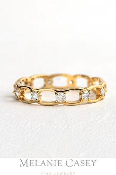 The Linked Eternity Band has a 14k gold motif that continues all the way around the band, with diamond accents enhancing each connection. Find this unique diamond ring at melaniecasey.com! Elegant Gold Eternity Band With Diamond Accents, Elegant Yellow Gold Infinity Eternity Band, Elegant Gold Eternity Band With Halo, Gold Infinity Eternity Band For Promise, Timeless Gold Promise Eternity Band, Timeless Yellow Gold Eternity Band For Promise, Elegant Gold Oval Eternity Band, Elegant Oval Gold Eternity Band, Gold Infinity Eternity Band For Anniversary